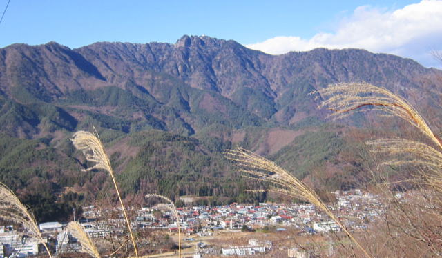 桂川の流れる富士急沿線の街の頭上に聳える
